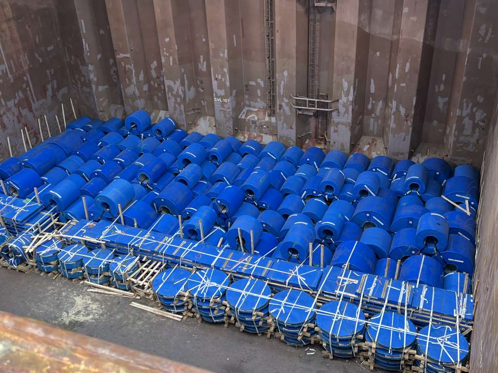 Cargo hold loaded with steel coils, secured and lashed